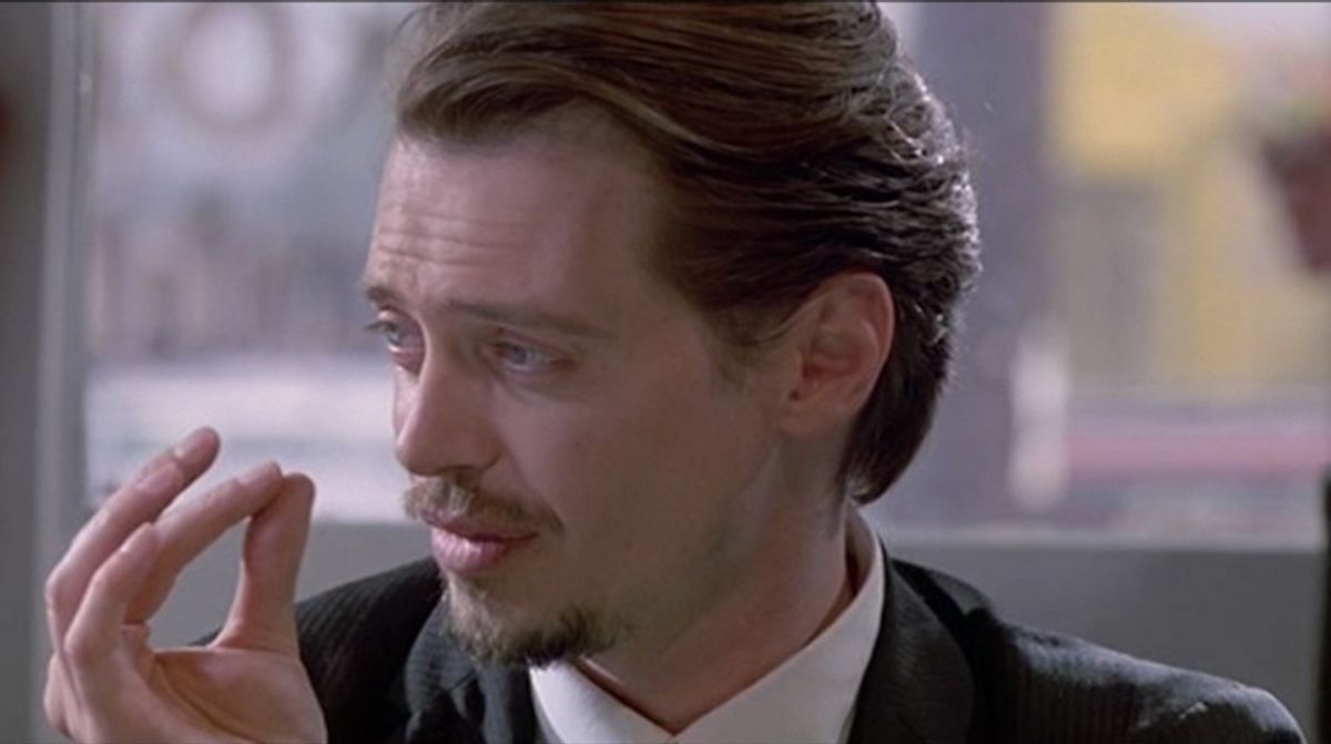 Image from reservoir dogs, Steve Buscemi playing the world's smallest violin for the waitresses